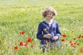 Cute young girl in poppy field Royalty Free Stock Photo