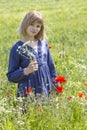 Cute young girl in poppy field Royalty Free Stock Photo