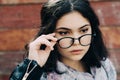 Beautiful happy hipster girl goes in the city. Closeup of trendy girl face. Royalty Free Stock Photo