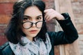 Beautiful happy hipster girl goes in the city. Closeup of trendy girl face. Royalty Free Stock Photo