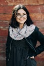 Beautiful happy hipster girl goes in the city. Closeup of trendy girl face. Royalty Free Stock Photo