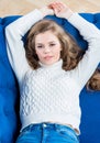 Cute young girl posing on couch in living room Royalty Free Stock Photo