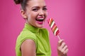 Cute young girl posing a lollipop on a stick Royalty Free Stock Photo