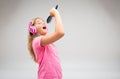 Cute young girl singing along to her music Royalty Free Stock Photo