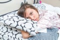 Cute young girl waking up in bed Royalty Free Stock Photo