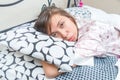 Cute young girl waking up in bed Royalty Free Stock Photo