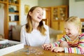 Cute young girls playing puzzles at home. Children connecting jigsaw puzzle pieces in a living room table. Kids assembling a