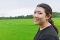 Cute young innocent asian teen smile with green rice field