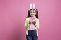 Cute young kid posing with a pink stuffed rabbit toy in studio Royalty Free Stock Photo