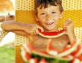 Cute young little boy with watermelon crustes smiling Royalty Free Stock Photo