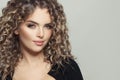 Cute young model woman with curly hair on white, fashion beauty portrait Royalty Free Stock Photo