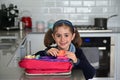 Cute young schoolgirl packing lunchbox Royalty Free Stock Photo