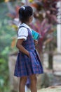 Cute young student girl with a book and a pencil