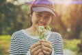 Cute Young Teen Girl happiness smiling hand holding grass flower outdoor with softly sunshine Royalty Free Stock Photo