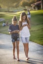 Cute young teen girls texting on their mobile cell phone outdoors Royalty Free Stock Photo