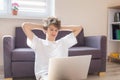 Cute young teenager with laptop on the couch at home. Boy makes homework with a computer. Distance, online education for children Royalty Free Stock Photo