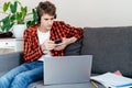 Cute young teenager with smartphone in his hands on the couch at home. Royalty Free Stock Photo