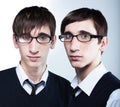 Cute young twins wearing glasses