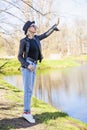 Cute Young Woman in Denim, Black Jacket and Hat Outdoors