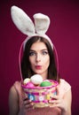 Cute young woman with an Easter egg basket Royalty Free Stock Photo