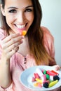 Cute young woman eating jelly candies with a fresh smile Royalty Free Stock Photo