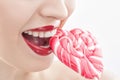 Cute young woman is eating sweet candy Royalty Free Stock Photo