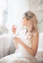 Cute young woman eating sweets in the morning in the bedroom. Gentle winter morning Royalty Free Stock Photo