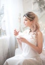 Cute young woman eating sweets in the morning in the bedroom. Gentle winter morning Royalty Free Stock Photo