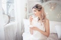 Cute young woman eating sweets in the morning in the bedroom. Gentle winter morning Royalty Free Stock Photo