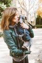 Cute young woman hugging and kissing her Italian Greyhound small breed of dog. Love between dog and owner. Outdoor photo, natural Royalty Free Stock Photo