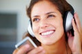 Cute young woman listening to music on headphones. Closeup of cute young woman listening to music on her mp3 player. Royalty Free Stock Photo