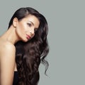 Cute young woman with long curly hair, makeup and clear skin, fashion portrait Royalty Free Stock Photo