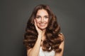 Cute young woman with long healthy brown curly hair smiling. Pretty female model portrait Royalty Free Stock Photo