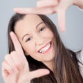 Cute young woman making hand frame Royalty Free Stock Photo