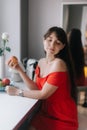 Cute young woman in red dress holding a large apple in her hand Royalty Free Stock Photo