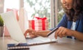 Cute young woman shopping online with her credit card and a tablet computer at home. Transfer money through internet banking Royalty Free Stock Photo