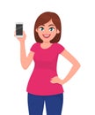 Cute young woman showing smartphone. Girl holding a mobile or cell phone in hand and holding hand on hip. Vector illustration. Royalty Free Stock Photo