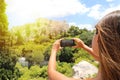 Cute young woman takes a picture of the Acropolis, Athens, Greece. Famous ancient Greek Acropolis is the main landmarks of Athens Royalty Free Stock Photo