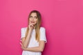 Cute Young Woman In White Shirt Is Looking Away Thinking Royalty Free Stock Photo