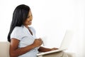 Cute young woman working on laptop at home Royalty Free Stock Photo