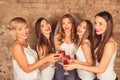 Cute young women wearing dress code celebrating hen-party with sparkling wine Royalty Free Stock Photo