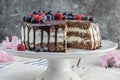 Cuted cake from Spelt flour with mascarpone cream and raspberries and blueberries for chocolate