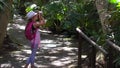 Little girl walking and photographing in the park