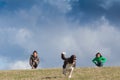 Cutes girls with a dog on a field in the summer