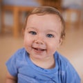 The cutest smile. Portrait of an adorable little infant sitting on the floor.