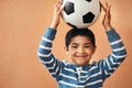 The cutest soccer player. Portrait of an adorable little boy posing with a soccer ball.