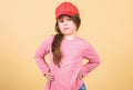 Cutie in cap. Kids fashion. Feeling confident with this cap. Girl cute child wear cap or snapback hat beige background