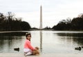 A cutie in front of Lincoln memorial with beautiful view of Washington monument