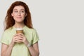 Cutie girl pose over grey studio background holding coffee cup Royalty Free Stock Photo