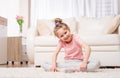 Preteen kid sitting in yoga pose in room